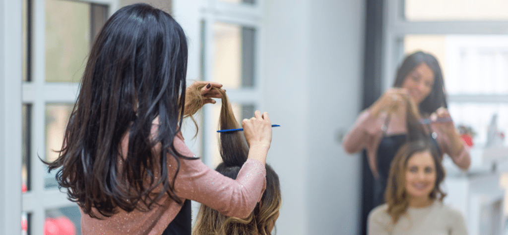 photo of woman cutting hair with new client from local business advertising