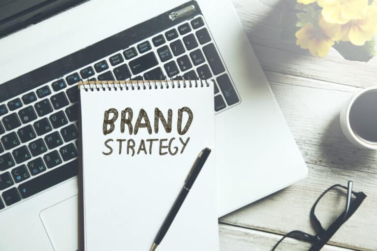 brand strategy text on notepad on keyboard for brand development