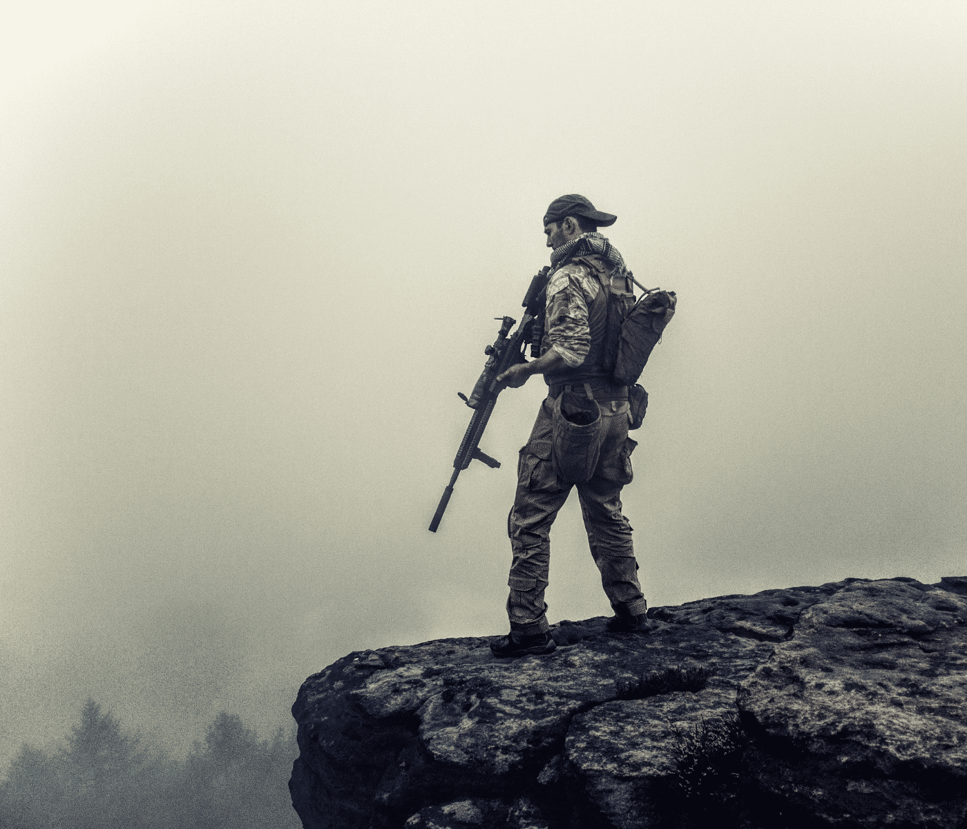 photo of soldier on cliff looking through fog in a tactical course he found online from tactical marketing for trainers