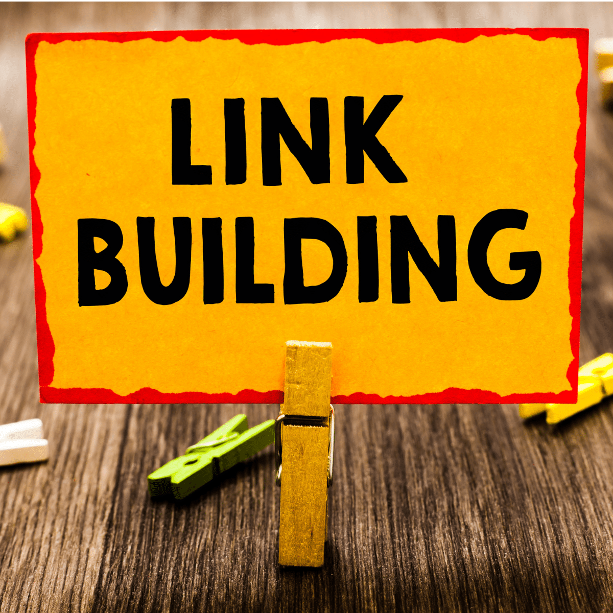 photo of sign being held up by paperclip that says link building services