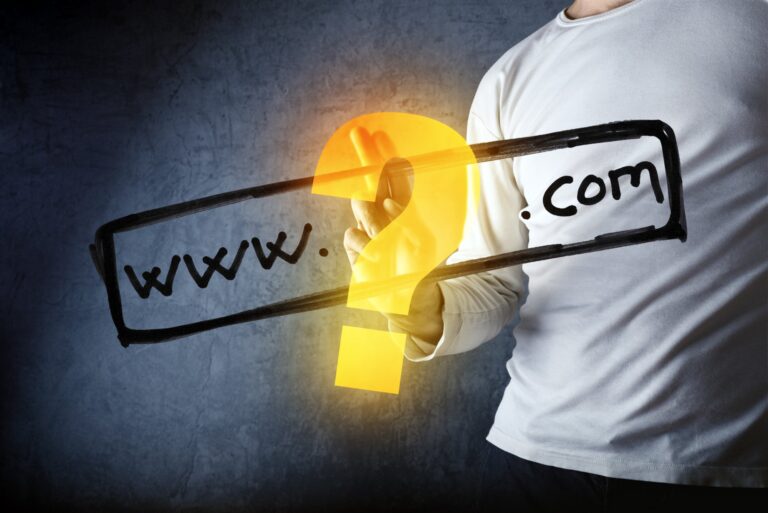 photo of man pointing at a domain with a question mark trying to decide on domain vs subdomain