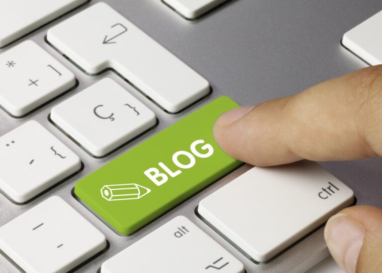 photo of keyboard with blog button and man pushing it for blog advertising