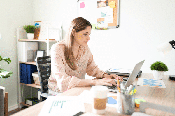 photo of woman on laptop creating effective email marketing campaigns for consultants