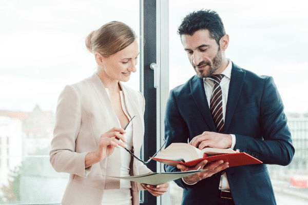 photo of two employees working on email marketing for consulting firms