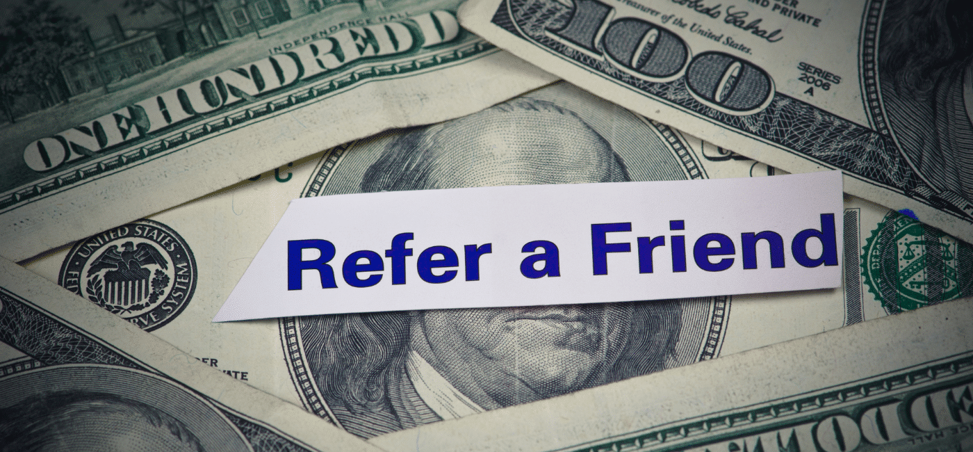 photo of $100 bills with refer a friend note representing our referral program for digital marketing